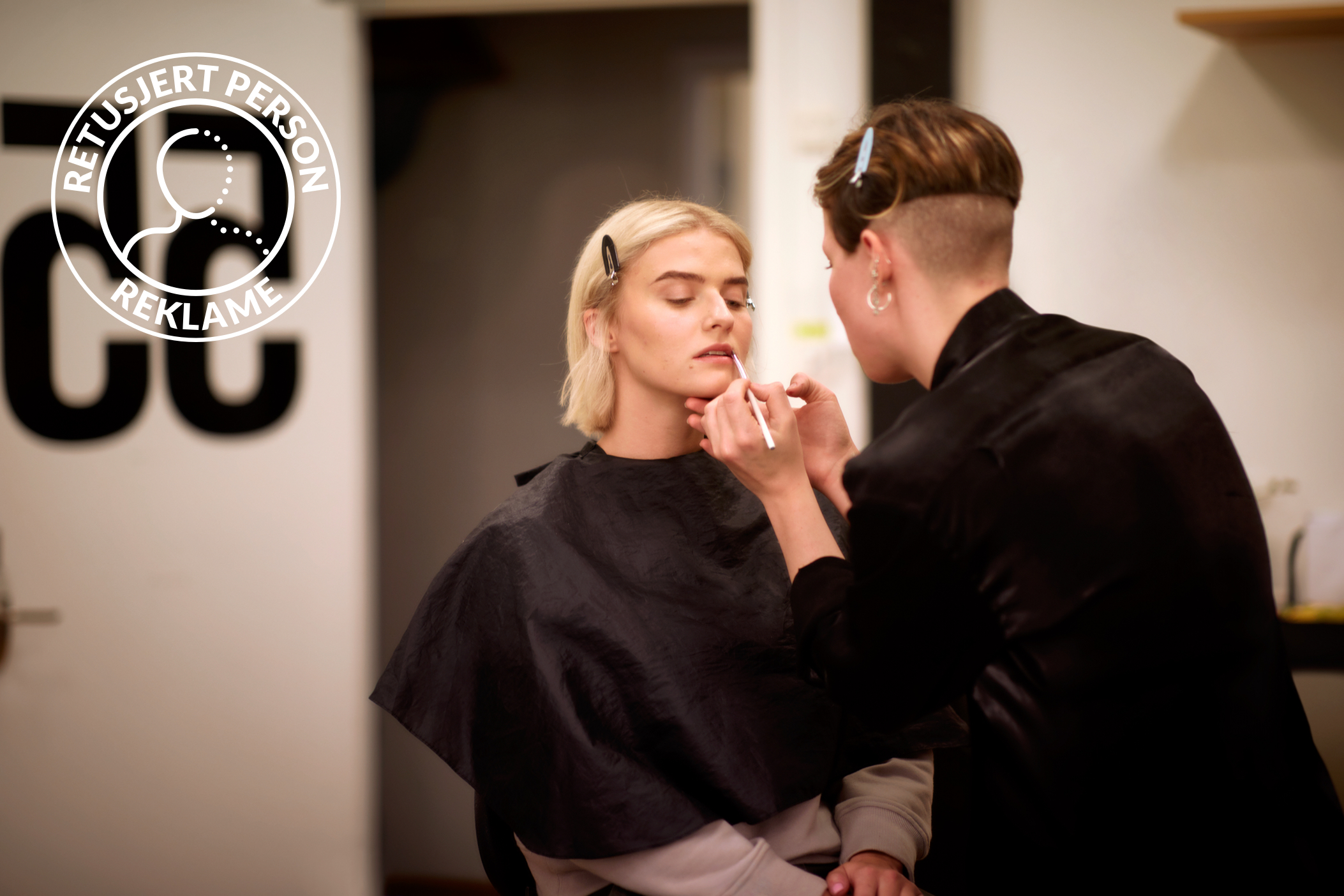 Female model getting her makeup done for a photoshoot. 
